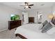 Carpeted main bedroom features a large TV and dark wooden dresser at 8304 Shooting Star Rd, Sarasota, FL 34241