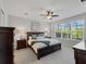 Comfortable carpeted bedroom with a ceiling fan and a large window offering lots of natural light at 8304 Shooting Star Rd, Sarasota, FL 34241