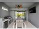 Covered patio with built in grill, mini fridge, and dining area is perfect for entertaining at 8304 Shooting Star Rd, Sarasota, FL 34241