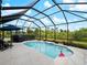 Sparkling pool inside a screened lanai offers a relaxing outdoor experience at 8304 Shooting Star Rd, Sarasota, FL 34241