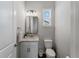 Bright powder room with contemporary vanity, mirror, and fixtures, complemented by a window for natural light at 8304 Shooting Star Rd, Sarasota, FL 34241