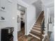 Carpeted stairway with dark wood accents and a view into the laundry room at 8304 Shooting Star Rd, Sarasota, FL 34241