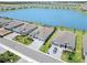 Picture of new gray homes in a sunny neighborhood that has well maintained lawns and landscaping at 8529 Saint Kitts Cir, Englewood, FL 34224