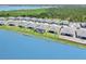 Picture of a row of houses in the community, and one backyard has a screened in pool in it at 8529 Saint Kitts Cir, Englewood, FL 34224