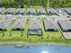 This aerial view shows a gorgeous pool with a screen in backyard next to the lake in the community at 8529 Saint Kitts Cir, Englewood, FL 34224
