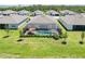 Picture of a screened in pool and well-maintained backyard with green grass and landscaping at 8529 Saint Kitts Cir, Englewood, FL 34224