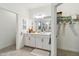 Light and bright bathroom features a walk in closet and double sink vanity at 8529 Saint Kitts Cir, Englewood, FL 34224