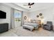 Spacious bedroom boasts tray ceilings, a ceiling fan, a king bed, and an accent wall at 8529 Saint Kitts Cir, Englewood, FL 34224