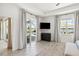 Bright bedroom featuring sliding doors to a screened-in patio and a view of the pool and lake at 8529 Saint Kitts Cir, Englewood, FL 34224