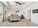 Bright and airy bedroom with tray ceilings, modern furniture, and a lovely view of the neighborhood at 8529 Saint Kitts Cir, Englewood, FL 34224