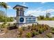 Beautiful community sign for Island Lakes at Coco Bay with lush landscaping and vibrant flowers at 8529 Saint Kitts Cir, Englewood, FL 34224