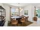 Dining room with modern light fixture, seating for six, and sliding glass doors to outdoor living space at 8529 Saint Kitts Cir, Englewood, FL 34224