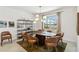 Modern dining room with stylish light fixture, seating for six, and a view of the water at 8529 Saint Kitts Cir, Englewood, FL 34224