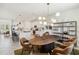 Dining area featuring modern lighting fixture and views into the kitchen and living room at 8529 Saint Kitts Cir, Englewood, FL 34224