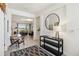 Inviting foyer with modern decor, tiled floor, and view of the open-concept living area at 8529 Saint Kitts Cir, Englewood, FL 34224