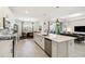 Open concept kitchen with large island, modern appliances, and view into the dining and living areas at 8529 Saint Kitts Cir, Englewood, FL 34224