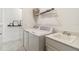 Laundry room with washing machine, dryer, utility sink, and decor at 8529 Saint Kitts Cir, Englewood, FL 34224