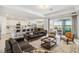 Open-concept living space featuring modern kitchen, living room, and dining area with ample natural light at 8529 Saint Kitts Cir, Englewood, FL 34224