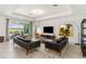 Spacious living room featuring modern furniture, tile flooring, and a sliding glass door to the patio at 8529 Saint Kitts Cir, Englewood, FL 34224