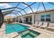 Private pool area with spa, lounge chairs, and outdoor dining at 8529 Saint Kitts Cir, Englewood, FL 34224