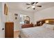 Comfortable bedroom featuring a ceiling fan, wooden floors, and matching wooden furniture at 8701 Pickwick Rd, North Port, FL 34287