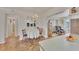 Charming dining area with chandelier lighting, neutral decor, and view of adjacent rooms at 8701 Pickwick Rd, North Port, FL 34287