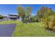Beautifully landscaped home with a cozy screened porch and a well-maintained yard, providing a charming and inviting curb appeal at 8701 Pickwick Rd, North Port, FL 34287