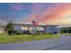 Charming single-story home with an American flag, lush lawn, and well-maintained landscaping at 8701 Pickwick Rd, North Port, FL 34287