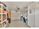Spacious garage with storage shelving, overhead lighting, and an automatic door, providing ample room for vehicles and storage at 8701 Pickwick Rd, North Port, FL 34287
