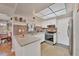 Open-concept kitchen with granite countertops, stainless appliances, and white cabinetry at 8701 Pickwick Rd, North Port, FL 34287