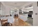 Bright kitchen and dining area featuring white cabinets, modern appliances, and tiled floors at 8701 Pickwick Rd, North Port, FL 34287