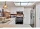 Well-equipped kitchen featuring updated appliances, stylish backsplash, and bright lighting at 8701 Pickwick Rd, North Port, FL 34287