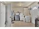 Spacious laundry room with a washer, dryer, utility sink, and ample storage space at 8701 Pickwick Rd, North Port, FL 34287