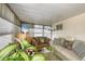Cozy living room featuring plush seating and natural light from the surrounding windows at 8701 Pickwick Rd, North Port, FL 34287