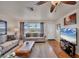 Comfortable living room with cozy sofas, a ceiling fan, and a bright window at 8701 Pickwick Rd, North Port, FL 34287