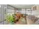 Cozy living room featuring plush seating and natural light from the surrounding windows at 8701 Pickwick Rd, North Port, FL 34287