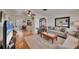 Bright living room featuring wood floors, comfortable sofas, and an open floor plan at 8701 Pickwick Rd, North Port, FL 34287