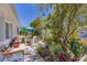 Picturesque patio with comfortable seating, a small table, and beautiful landscaping, ideal for outdoor relaxation and enjoyment at 8701 Pickwick Rd, North Port, FL 34287