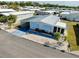 An aerial view of a well-maintained home showcases its attractive landscaping and convenient carport, enhancing curb appeal at 881 Grado Dr, Venice, FL 34285