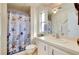 Charming bathroom features a tub and shower combo and a large vanity with ample storage space at 881 Grado Dr, Venice, FL 34285