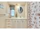 Charming bathroom with seashell-themed shower curtain, vanity, and mirror at 881 Grado Dr, Venice, FL 34285