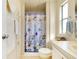 Charming bathroom features a shower and tub combo, a decorative shower curtain, and ample storage at 881 Grado Dr, Venice, FL 34285