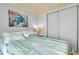 Cozy bedroom features a sliding closet, a plush bed, and a coastal-themed decor at 881 Grado Dr, Venice, FL 34285