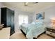 Cozy bedroom featuring a ceiling fan, nautical-themed decor, and natural light from the window at 881 Grado Dr, Venice, FL 34285