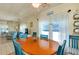 Inviting dining room with a wood table, coastal decor, and plenty of natural light from the surrounding windows at 881 Grado Dr, Venice, FL 34285