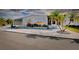 Charming home with tropical landscaping, featuring palm trees and a covered parking area at 881 Grado Dr, Venice, FL 34285