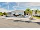 Charming single-story home with manicured landscaping, palm trees, and a carport at 881 Grado Dr, Venice, FL 34285