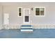 Inviting front entrance with a well-maintained door, a small porch, and charming decorative concrete block accents at 881 Grado Dr, Venice, FL 34285