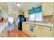 Cozy kitchen with laminate countertops, wooden cabinets and plenty of natural light at 881 Grado Dr, Venice, FL 34285