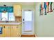 Bright eat-in kitchen features light wood cabinets, a window, and a back door for easy outdoor access at 881 Grado Dr, Venice, FL 34285